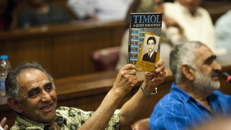 Mohamed Timol, brother of late Ahmed Timol holds up a book by Imtiaz Cajee, nephew of Ahmed Timol